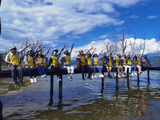 Teva employees raising hands outside in Dali