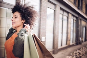 A woman confidently walks with her shopping and her ADHD impulsivity under control