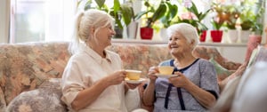 daughter and aging mother drinking coffee