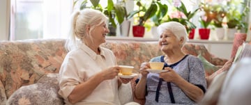 daughter and aging mother drinking coffee