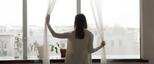 woman-looking-through-the-window